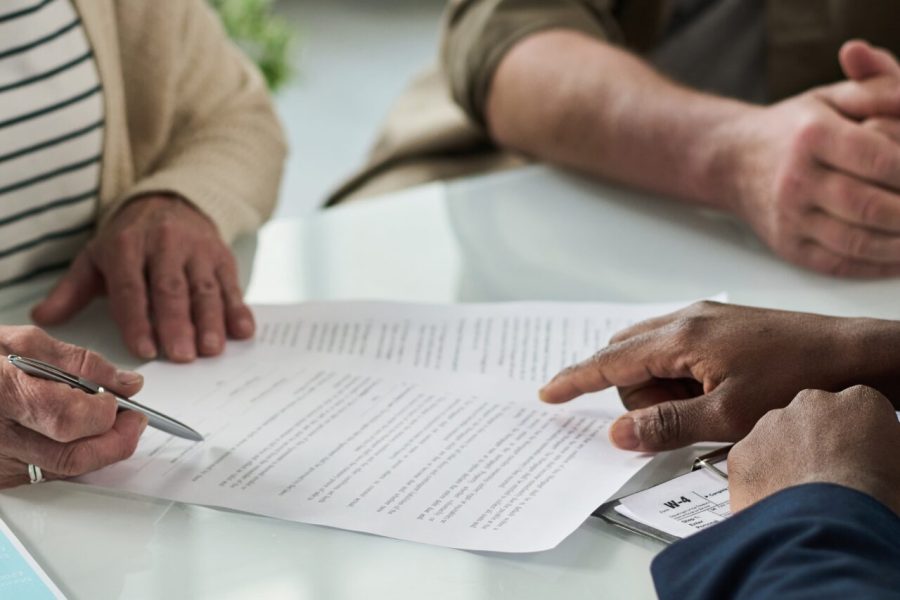 Senior,Couple,Signing,Contract,At,Meeting
